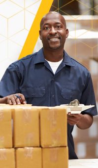 smiling man with clipboard standing behind boxes
